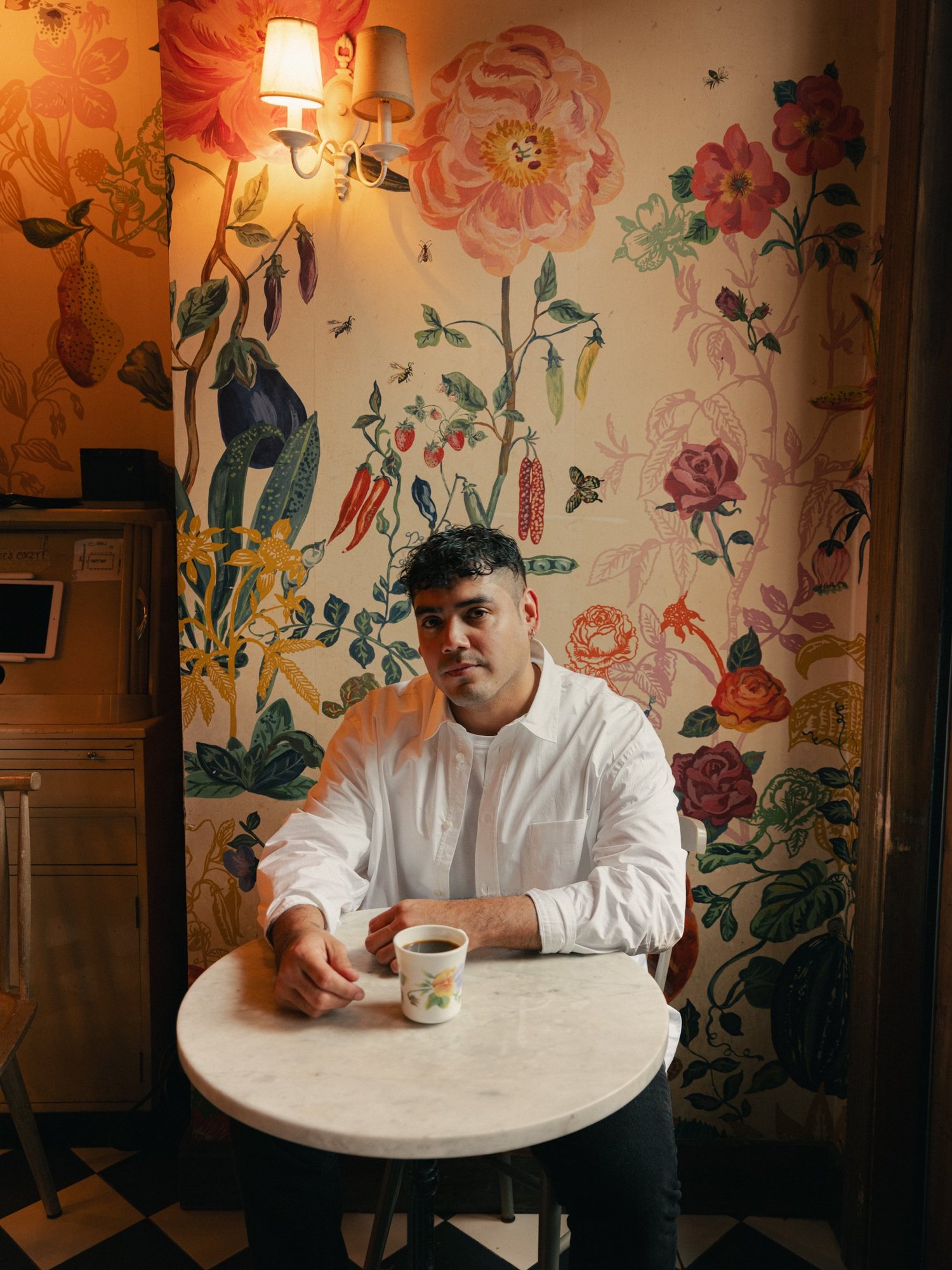 Saul Flores seated at a café table